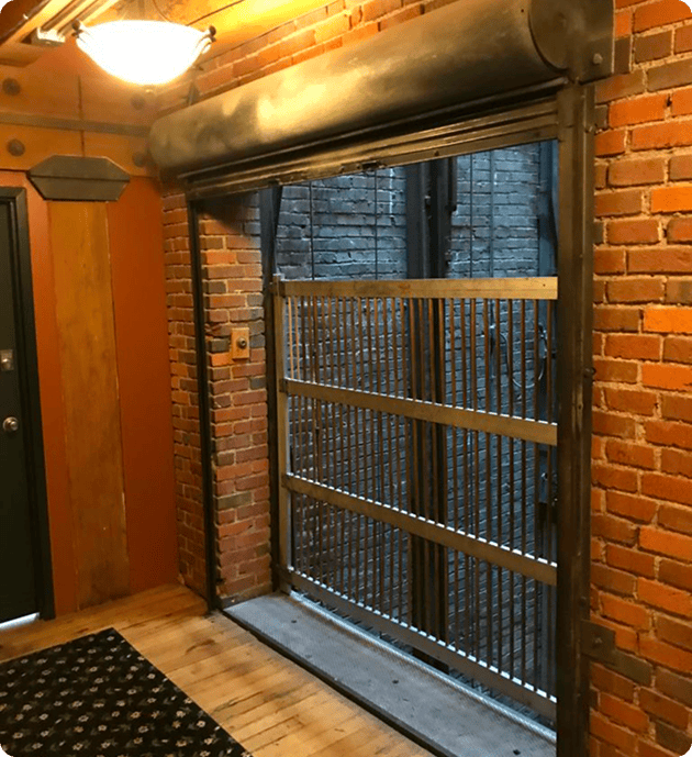 Freight elevator with open metal gate.